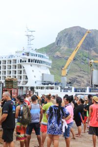 people in front of big ship